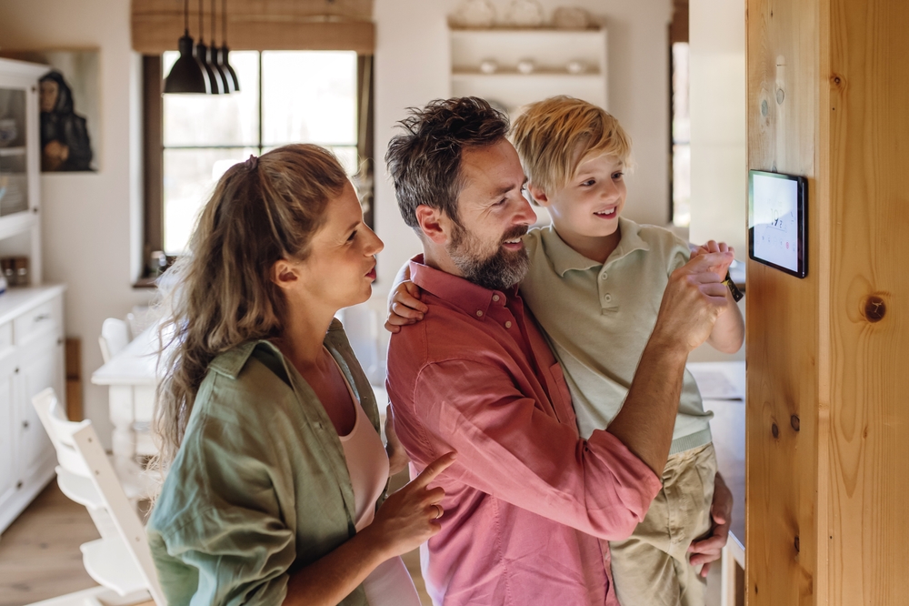 Family using thermostat in home